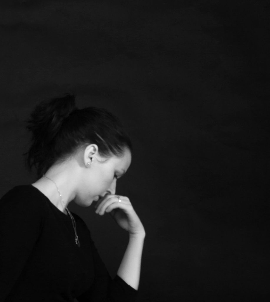 A girl in deep thought signifying suicide consideration