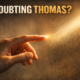 A hand reaching toward a glowing point of light with the words Doubting Thomas above it