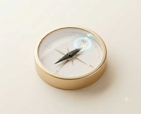 Gold compass on a light surface with its needle slightly off center